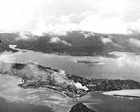 Photo # NH 97743: Fires burning on Tulagi during attacks by Navy planes, 7 August 1942