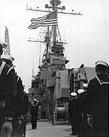 Photo # NH 99022:  Raising the National Ensign as USS Spokane goes into commission, 17 May 1946