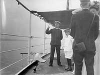 Photo # NH 99046: Captain Edward Taussig with guests, probably on board USS Massachusetts, circa 1905-1906