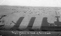Photo # NH 101493:  A Great White Fleet battleship casts its shadow on the banks of the Suez Canal, January 1909