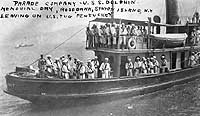 Photo # NH 103283:  Parade company from USS Dolphin on board U.S. Tug Pentucket off Rosebank, Staten Island, on a pre-World War I Memorial Day