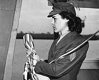 Photo # NH 103377:  Sgt. Lena Mae Basilone, USMC(WR) prepares to christen USS Basilone, 21 December 1945