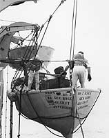 Photo # NH 103404: Lowering a lifeboat during a boat drill in the late 1950s or early 1960s on USNS General Maurice Rose.