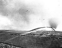 Photo # SC 127014 (U.S. Army Photograph):  Two Japanese bombers fly near a U.S. Army B-17E, during the 7 December 1941 Pearl Harbor raid.