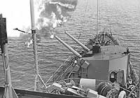 Photo # USN 1119540:  USS Newman K. Perry's forward five-inch guns fire on enemy positions ashore in Vietnam, 16 Dec. 1966