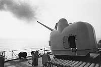 Photo # USN 1133001:  One of USS Turner Joy's 5-inch guns firing off Vietnam, June 1968