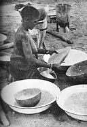Native housewife sifting flour