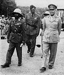 Lieut.-General Alan Cunningham <i>(right),</i> with the Emperor Haile Selassie, on the Emperor's return to Addis Ababa a month after it had been entered by South African, East African and West African troops.