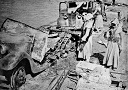 Men of the Arab Legion and the débris of an Iraqi transport column