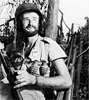 BATTLE-WEARY MARINE grins at cameraman during the hard fight on Peleliu