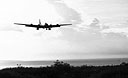 BOEING B-29 SUPERFORTRESS coming in for a landing after the raid