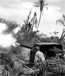 CAPTURED JAPANESE NAVAL GUN BEING FIRED by an American soldier in the Admiralties