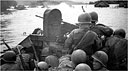 Men in a Buffalo, LVT(A) (2), are firing a machine gun at enemy riflemen