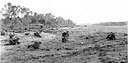 INFANTRYMEN CROSS THE KAMIRI AIRSTRIP, keeping low to avoid enemy fire