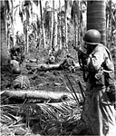 MEN CAUTIOUSLY MOVING IN on an enemy machine gun position, 24 October