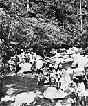 PHILIPPINE CIVILIANS carrying supplies to the front for U.S. troops