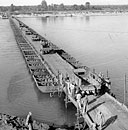 U.S. SERVICES OF SUPPLY TRUCK CONVOY starting across a temporary ponton bridge