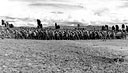 hundreds of Chinese laborers pull a roller to smooth a runway for an airstrip