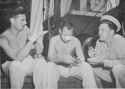 TWO ARMY MEN AND A COAST GUARDSMAN COMPARE NOTES ON THE INVASION AT GELA, SICILY. FRANCIS McGUNNIFF, LEFT, WAS STRUCK BY A BULLET WHEN LANDING ON THE BEACH WITH THE FIRST WAVE. WILLIAM KILPATRICK WAS WOUNDED IN THE EXPLOSION OF A LANDING MINE WHILE ADVANCING UPON THE TOWN OF GELA. WILLIAM FORSYTHE, SHOWN AT THE RIGHT, IS A COAST GUARD COMBAT PHOTOGRAPHER AND FORMER WASHINGTON, D.C. NEWSPAPERMAN.