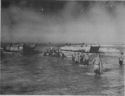 DOWN COME THE RAMPS AS COAST GUARD LANDING CRAFT HIT THE BEACH DURING THE INVASION OF SICILY