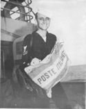 THIS U.S. COAST GUARDSMAN HAS A USEFUL SOUVENIR OF THE FIGHTING IN THE NAPLES AREA--AN ITALIAN MAIL BAG