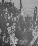 U.S. SOLDIERS INVADING ITALY LINE THE RAIL OF A COAST GUARD-MANNED COMBAT TRANSPORT