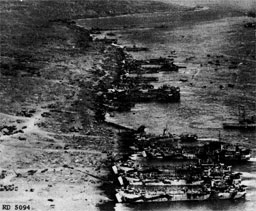 Figure 12.--General unloading of large landing craft directly on the beach (at Iwo Jima). Note beach roadway and dispersal of supplies unloaded.