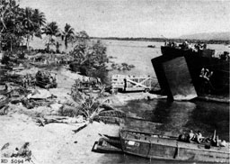 Figure 4.--LST unloading directly on beach. Note ramp built out to facilitate vehicular access. (South Saipan, Marianas Islands.