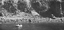 Lt. Raymond P. Shafer, USNR, and Lt. (jg.) Charles Adams, USNR, approach Corregidor beach to pick up paratroopers under Japanese sniper fire