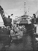 PT's of Squadron 37 being eased into their cradles in Oak Hill (LSD 7) at Espiritu Santo on July 24, 1945, for shipment to Okinawa